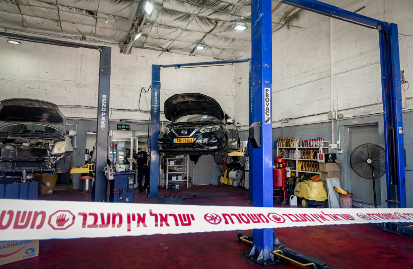  Police at the scene where a worker at a garage stabbed by a Jordanian worker in a suspect terror stabbing attack, in Petah Tikva, August 10, 2023 (credit: AVSHALOM SASSONI/FLASH90)