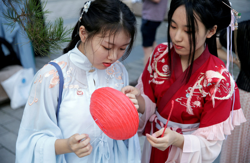  Girls dressed in ''Hanfu'', or Han clothing, prepare for an event to mark the traditional Qixi festival, the Chinese equivalent of Valentine's Day, at a park in Beijing, China, August 7, 2019.  (credit: REUTERS/JASON LEE/FILE PHOTO)