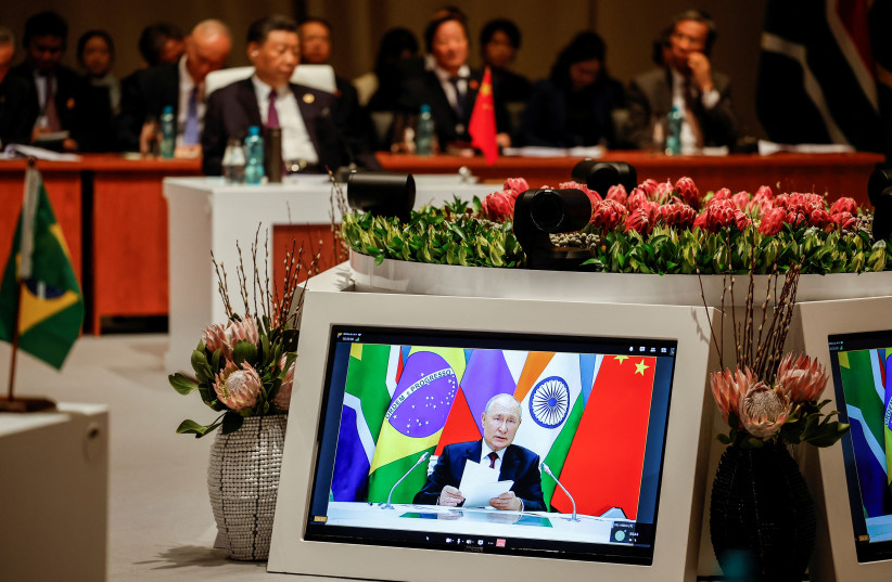  President of China Xi Jinping attends the plenary session as Russian President Vladimir Putin delivers his remarks virtually during the 2023 BRICS Summit at the Sandton Convention Centre in Johannesburg, South Africa on August 23, 2023 (credit: GIANLUIGI GUERCIA/POOL VIA REUTERS)