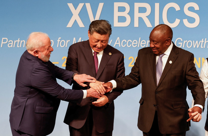  President of Brazil Luiz Inacio Lula da Silva, President of China Xi Jinping and South African President Cyril Ramaphosa gesture during the 2023 BRICS Summit at the Sandton Convention Centre in Johannesburg, South Africa on August 23, 2023 (credit: GIANLUIGI GUERCIA/POOL VIA REUTERS)