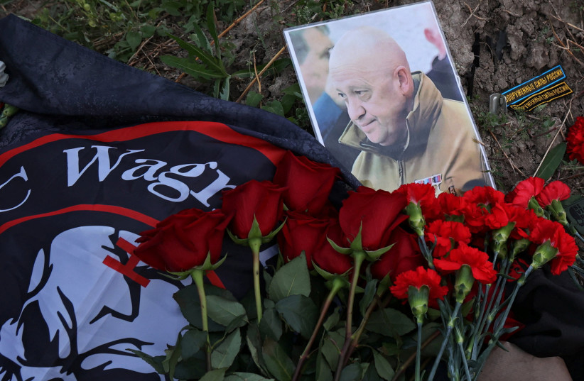  A view shows a portrait of Wagner mercenary chief Yevgeny Prigozhin at a makeshift memorial near former PMC Wagner Centre in Saint Petersburg, Russia August 24, 2023.  (credit:  REUTERS/Anastasia Barashkova)