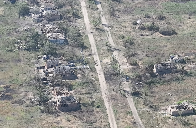  Ukrainian soldiers of the Separate Assault Battalion 'Skala' enter the embattled village of Robotyne, Zaporizhzhia region, Ukraine, in this screengrab taken from a handout video released on August 25, 2023. (credit: Separate Assault Battalion 'Skala' of the Ukrainian Armed Forces/Handout via REUTERS)
