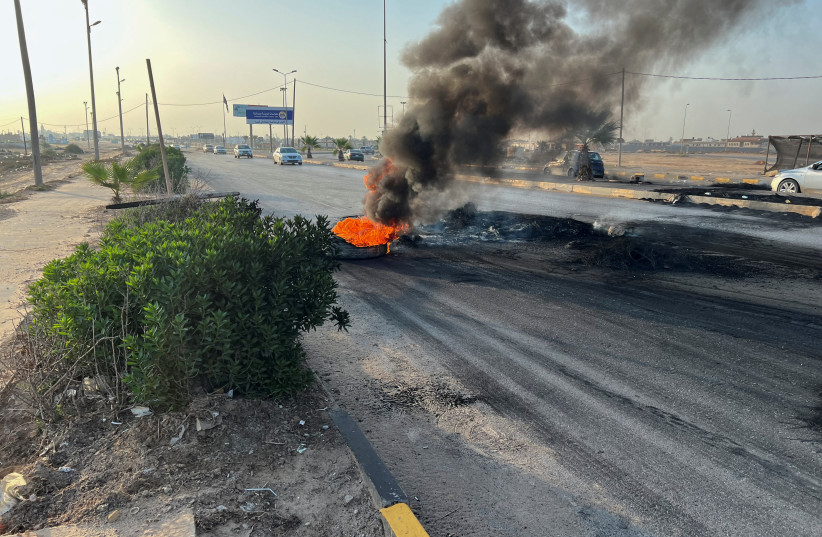 Tires burn on the road as people protest against the meeting which was held last week in Italy between foreign affairs ministers of Libya and Israel, in Tripoli, Libya, August 28, 2023 (credit: REUTERS/AYMAN AL-SAHILI)