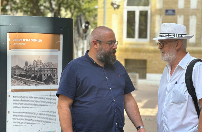  Ladislav Trajer, left, and Mirko Štark, the top two leaders of the Jewish community in Novi Sad, chat just outside the entrance to their synagogue. (credit: LARRY LUXNER/JTA)