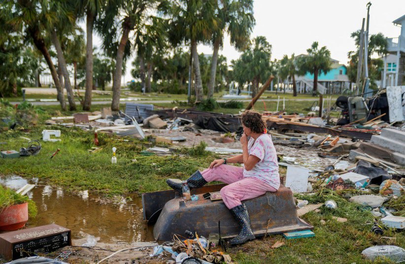 Jewell Baggett, 51, sits on a bathtub amid the wreckage of the home built by her grandfather, where she grew up and three generations of her family lived, and which Hurricane Idalia had reduced to rubble, in Horseshoe Beach, Florida, U.S., August 30, 2023. (credit: REUTERS/Cheney Orr)