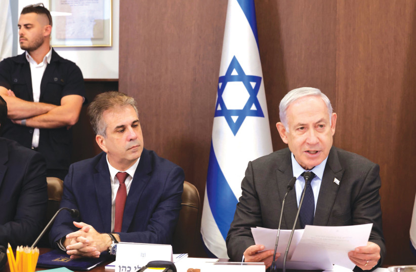  FOREIGN MINISTER Eli Cohen sits next to Prime Minister Benjamin Netanyahu at a cabinet meeting in Jerusalem in July. (credit: MARC ISRAEL SELLEM/THE JERUSALEM POST)
