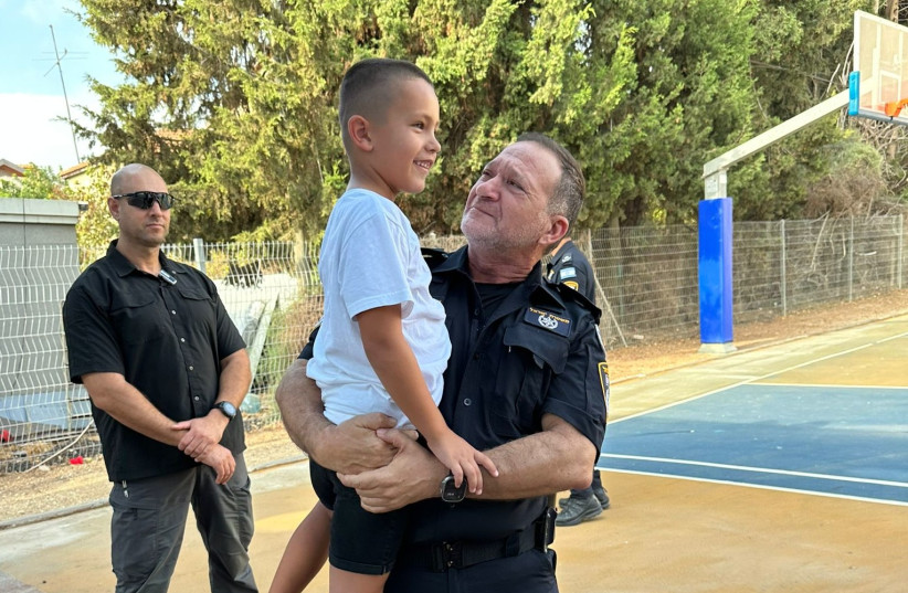  Police Chief Kobi Shabtai takes 7-year-old Nikita Olynik to his first day of school on September 1, 2023.  (credit: POLICE SPOKESPERSON'S UNIT)