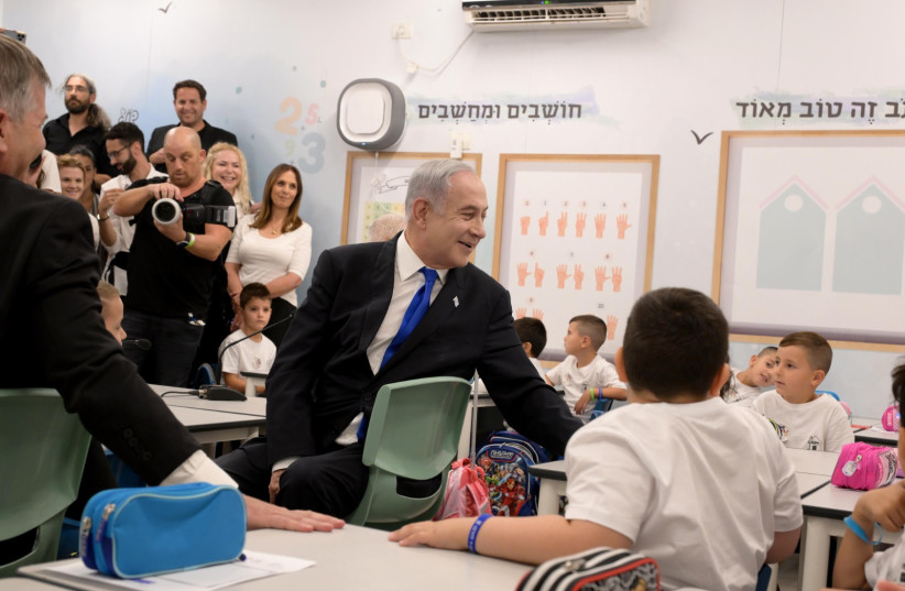 Prime Minister Benjamin Netanyahu visits an Israeli primary school on the first day of school on September 1, 2023 (credit: Avi Ohayon/GPO)