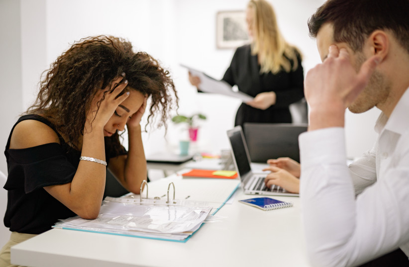   Stressed workers in an office. (credit: PEXELS)