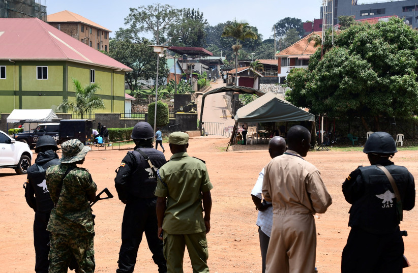  Ugandan police officers gather near a scene with an explosive device outside a Pentecostal church, Lubaga Miracle Centre, in the Lubaga suburb of south Kampala, Uganda September 3, 2023. (credit:  REUTERS/ABUBAKER LUBOWA)