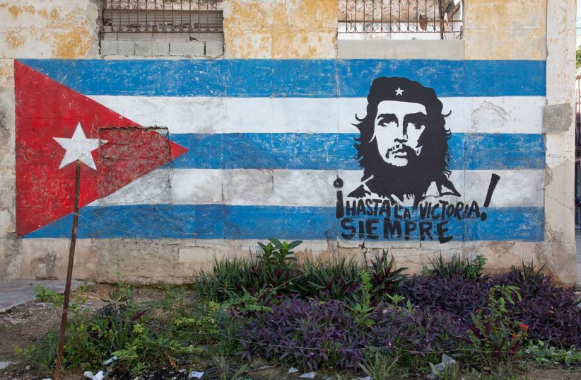  A hand painted mural of Che Guevera over a Cuban flag. (credit: PICRYL)