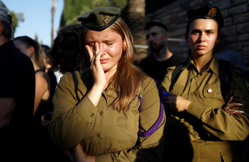  People mourn Maksym Molchanov, an Israeli soldier who moved to Israel from Ukraine and was killed in a ramming attack adjacent to the Maccabim Checkpoint, at his funeral in Tel Aviv, Israel September 5, 2023 (credit: REUTERS)