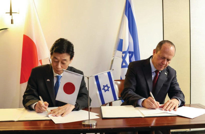  SHIGEYUKI GOTO, Japan’s minister for economic revitalization, and Economy Minister Nir Barkat sign an agreement at the Dan Hotel, Tel Aviv. (credit: ARIEL ZANDBERG)