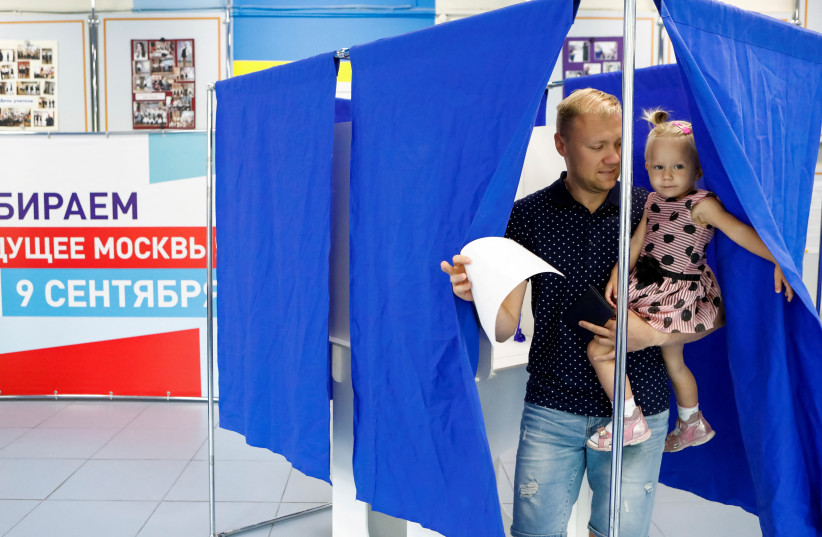  A man leaves a voting booth during mayoral election at a polling station in Moscow, Russia September 9, 2018. (credit: REUTERS)