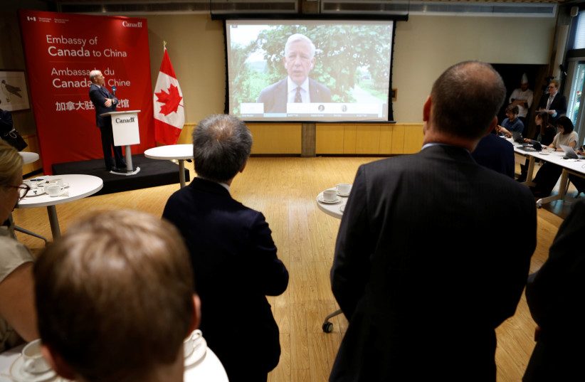  Canadian Ambassador to China Dominic Barton speaks to journalists and diplomats via video link from Dandong, where a local court ruled on the case of Michael Spavor, charged with espionage in June 2019, at the Canadian embassy in Beijing, China August 11, 2021 (credit: REUTERS)