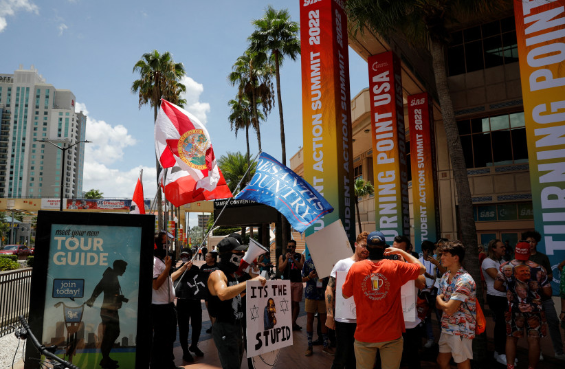   People wearing antisemitic and nazi symbols argue with conservatives during a protest outside the Tampa Convention Center where the Turning Point USA’s (TPUSA) Student Action Summit (SAS) is held, in Tampa, Florida, U.S. July 23, 2022.  (credit: REUTERS/MARCO BELLO)