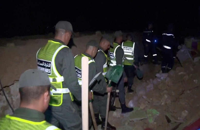  First responders walk through the rubble during the aftermath of an earthquake in Chiachaoua, Morocco, September 9, 2023 in this screen grab obtained from a video. (credit: AL OULA TV/VIA REUTERS)