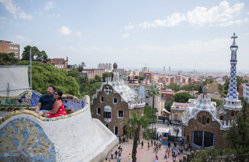  People visit at Park Guell in Barcelona, Spain, on August 18, 2019 (credit: YONATAN SINDEL/FLASH90)