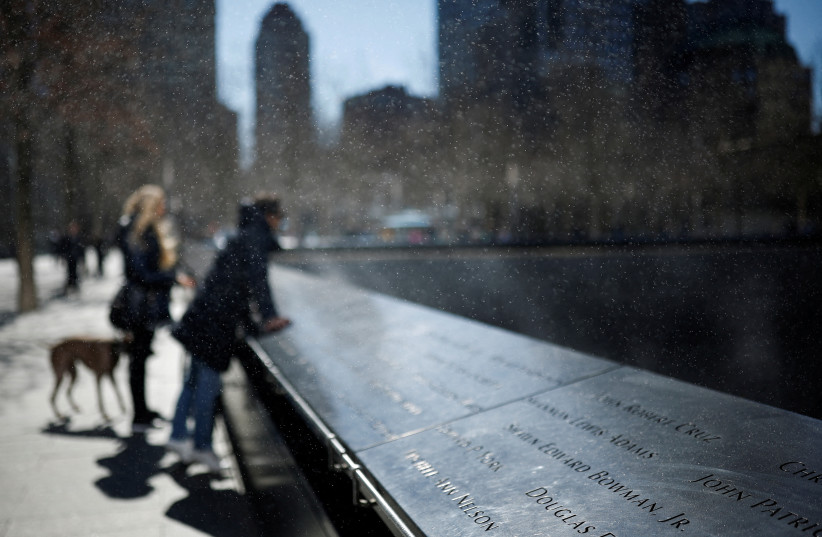 People visit the 9/11 Memorial, in New York City, US, March 21, 2023. (credit: REUTERS/AMANDA PEROBELLI)