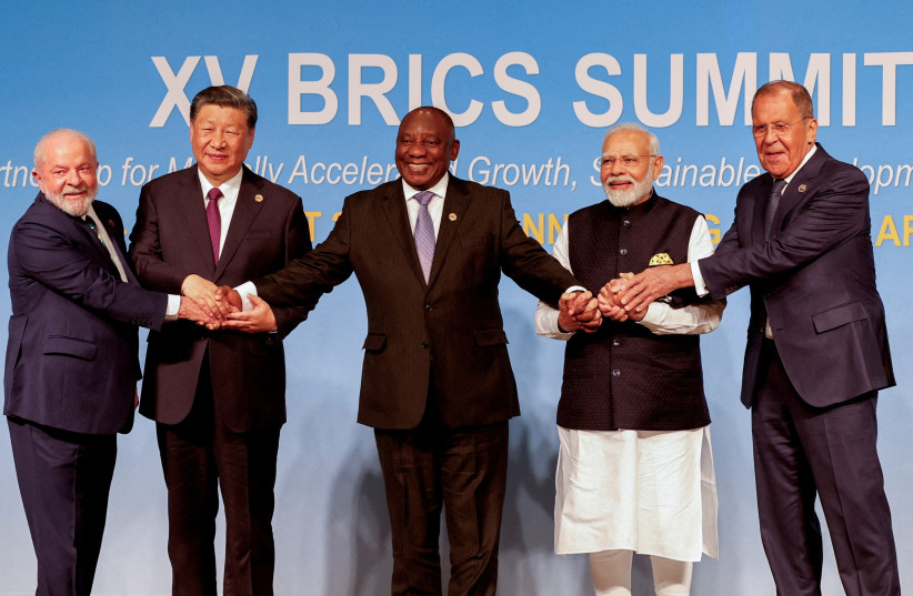 President of Brazil Luiz Inacio Lula da Silva, President of China Xi Jinping, South African President Cyril Ramaphosa, Prime Minister of India Narendra Modi and Russia's Foreign Minister Sergei Lavrov pose for a BRICS family photo during the 2023 BRICS Summit at the Sandton Convention Centre in Joha (credit: GIANLUIGI GUERCIA/POOL VIA REUTERS)