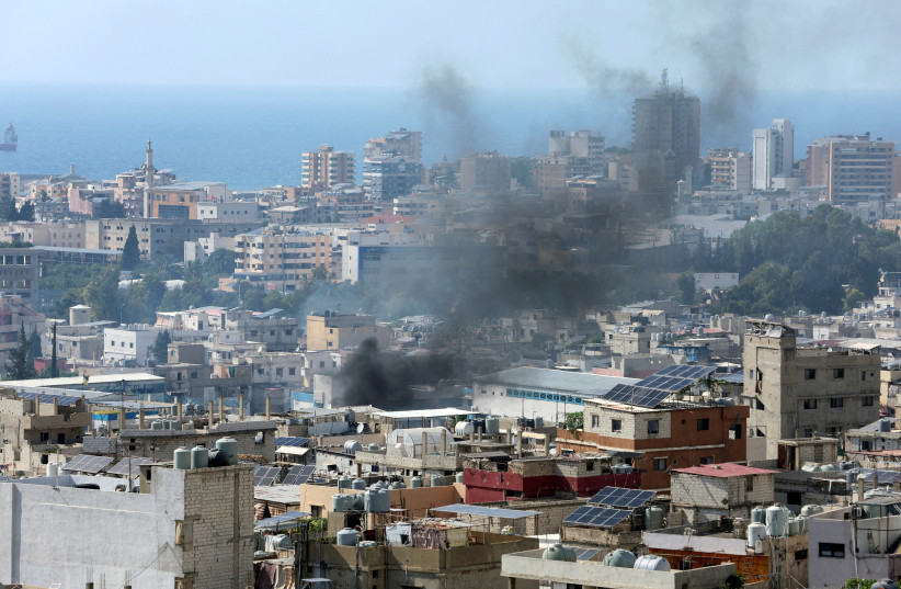  Smoke rises from Ain el-Hilweh Palestinian refugee camp during a previous round of Palestinian factional clashes, in Sidon, Lebanon, July 30, 2023.  (credit: REUTERS/AZIZ TAHER)