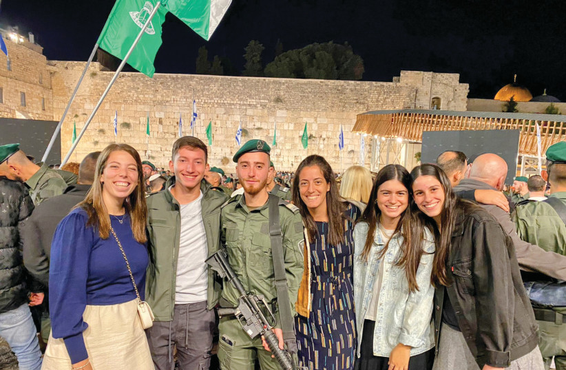  A GRADUATE at his IDF swearing-in ceremony at the Western Wall, with a fellow graduate and Bet Elazraki staff. (credit: Yosi Dinershtain, Zili Shafir)