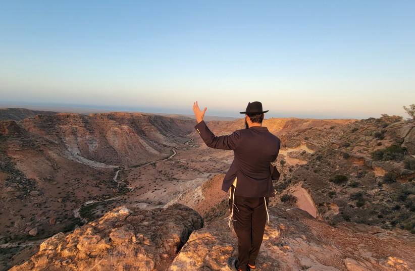  Rabbi Mendel Junik prays while overlooking the rugged outback of the Pilbara region in western Australia. (credit: COURTESY/RABBI MENACHEM ARON)