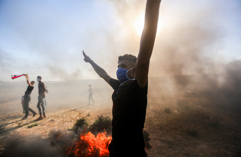 Palestinian demonstrators clash with Israeli soldiers at the Israel-Gaza border fence, east of Gaza City September 15, 2023 (credit: ATIA MOHAMMED/FLASH90)