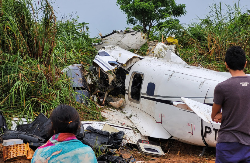 People look at the aircraft after it crashed, which has left 14 dead in Barcelos, Amazonas State Brazil September 16, 2023. (credit: REUTERS/Wellington Melo)