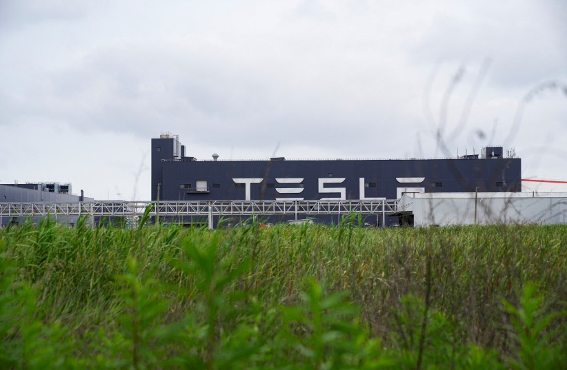  A view of a Tesla sign at its factory in Shanghai, China June 12, 2023 (credit: REUTERS/ALY SONG/FILE PHOTO)