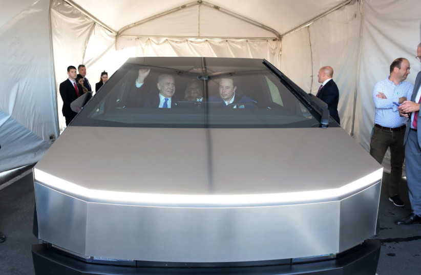  Prime Minister Netanyahu and his wife Sarah are with Elon Musk inside Tesla's Cybertruck car, which has not been released to the market. (credit: Avi Ohayon/GPO)