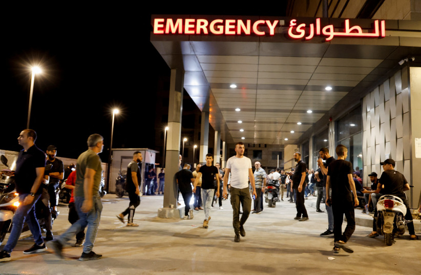 People stand outside a hospital, during an Israeli raid in Jenin, in the West Bank, September 19, 2023. (credit: RANEEN SAWAFTA/REUTERS)