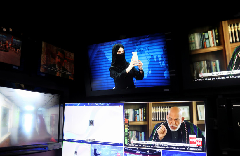 A female presenter for Tolo News takes a selfie in a newsroom while her face is covered at Tolo TV station in Kabul (credit: REUTERS)