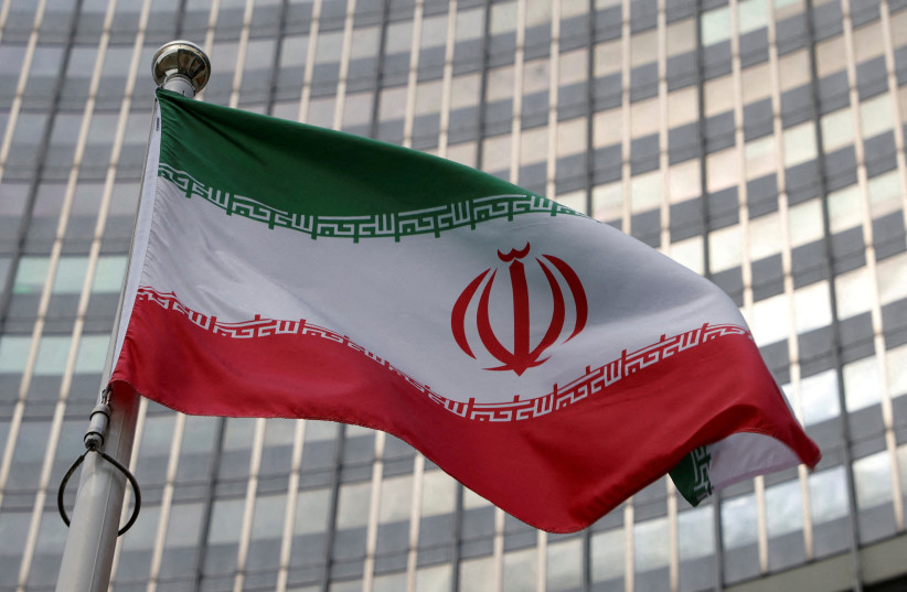  The Iranian flag flutters in front of the International Atomic Energy Agency (IAEA) organisation's headquarters in Vienna, Austria, June 5, 2023. (credit: REUTERS/LEONHARD FOEGER)