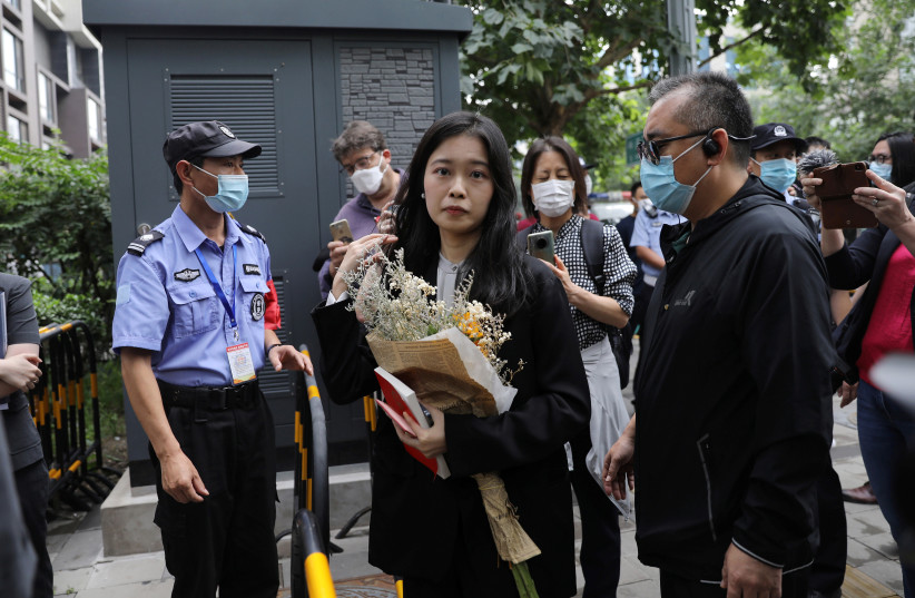  Zhou Xiaoxuan, also known by her online name Xianzi, arrives at a court for a sexual harassment case involving a Chinese state TV host, in Beijing, China September 14, 2021 (credit: REUTERS)