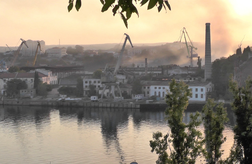  Smoke rises from the shipyard that was reportedly hit by Ukrainian missile attack in Sevastopol, Crimea, in this still image from video taken September 13, 2023. (credit: REUTERS TV via REUTERS)