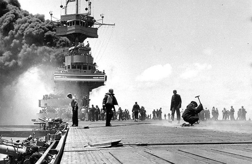 Scene on board USS Yorktown (CV-5), during the Battle of Midway, June 1942, shortly after she was hit by three Japanese bombs on 4 June 1942. Dense smoke is from fires in her uptakes, caused by a bomb that punctured them and knocked out her boilers. (credit: 2nd Class William G. Roy/US Navy)