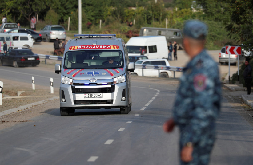 An ambulance heading from Nagorno-Karabakh region drives past a checkpoint in the village of Kornidzor, Armenia, September 24, 2023 (credit: REUTERS/IRAKLI GEDENIDZE)
