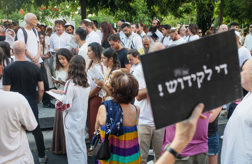  Jews pray while activists protest against gender segregation in the public space during a public prayer on Dizengoff Square in Tel Aviv, on Yom Kippur, the Day of Atonement, and the holiest of Jewish holidays, September 25, 2023.  (credit: ITAI RON/FLASH90)