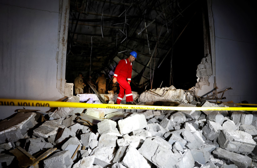  An emergency worker walks over rubble at the site following a fatal fire at a wedding celebration, in the district of Hamdaniya in Iraq's Nineveh province, Iraq, September 27, 2023.  (credit: REUTERS/KHALID AL-MOUSILY)
