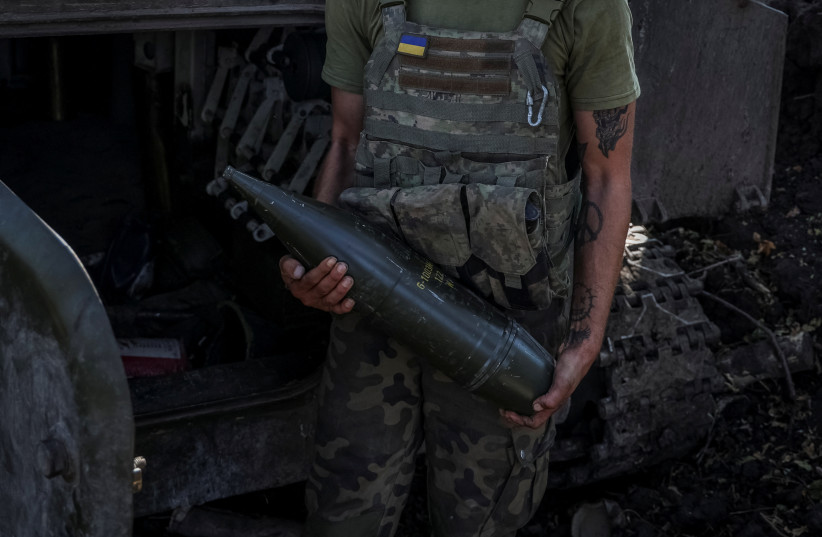 A Ukrainian serviceman of the 10th separate mountain assault brigade 'Edelveis' of the Armed Forces of Ukraine holds an artillery shell,  Ukraine Septtember 26, 2023 (credit: REUTERS/OLEKSANDR RATUSHNIAK)
