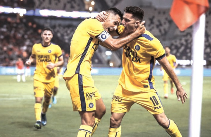  MACCABI TEL AVIV teammates Eran Zahavi (left) and Dan Bitton celebrate a goal in the yellow-and-blue’s 5-0 derby victory over Hapoel Tel Aviv at Bloomfield Stadium. (credit: MACCABI TEL AVIV/COURTESY)