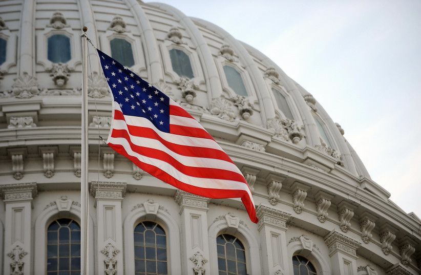  THE AMERICAN flag flies high at the US Capitol in Washington. (credit: STAN HONDA/AFP via Getty Images)