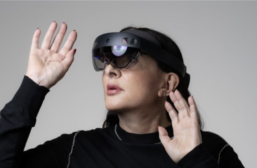 Marina Abramovic engages with mixed reality technology.