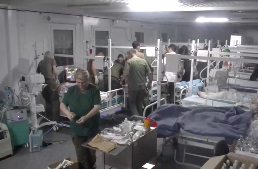  Medics of the Russian peacekeeping troops treat people injured in an explosion at a fuel depot outside Stepanakert, in an unknown location in Nagorno-Karabakh, a region inhabited by ethnic Armenians, in this still image from video published September 26, 2023. (credit: RUSSIAN DEFENSE MINISTRY/HANDOUT VIA REUTERS)
