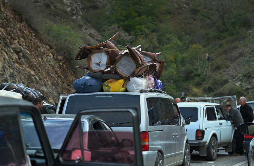  Vehicles carrying refugees from Nagorno-Karabakh, a region inhabited by ethnic Armenians, queue on the road leading towards the Armenian border, in Nagorno-Karabakh, September 26, 2023. (credit: REUTERS/DAVID GHAHRAMANYAN)