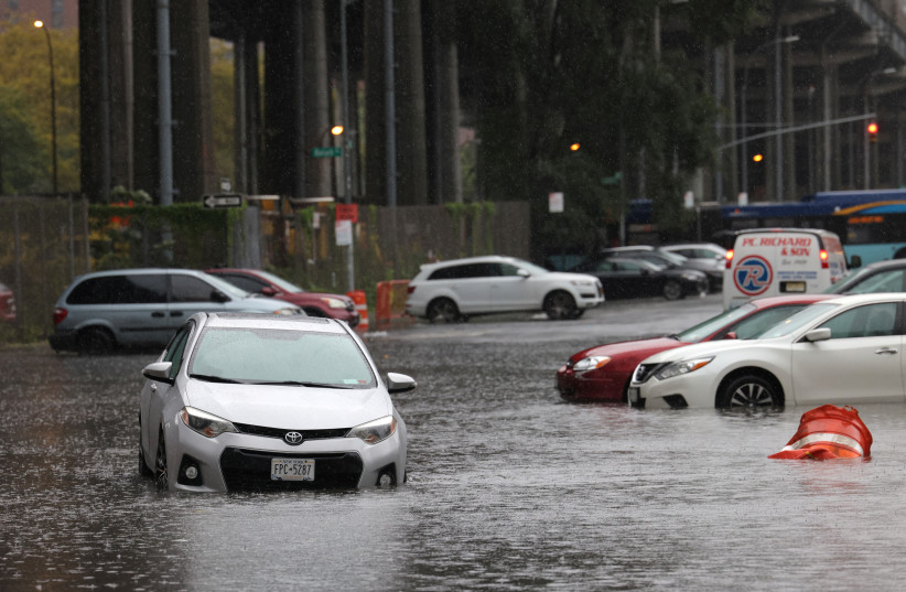 Cars are submerged in a flooded street after heavy rains as the remnants of Tropical Storm Ophelia bring flooding across the mid-Atlantic and Northeast, in New York City, U.S., September 29, 2023. (credit: Andrew Kelly/Reuters)