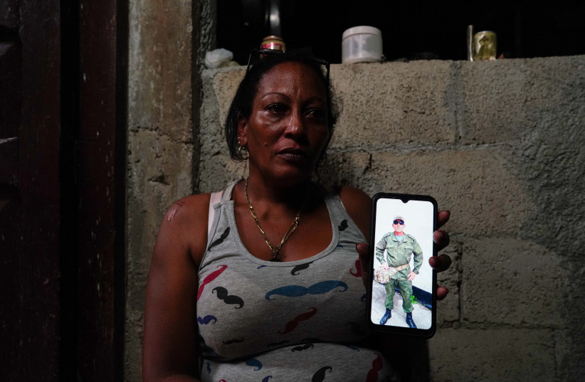  Yamidely Cervantes, 42, shows an undated photo of her husband Enrique Gonzalez, 49, dressed in military uniform in a bootcamp in Russia, La Federal, Cuba, September 19, 2023 (credit: REUTERS)