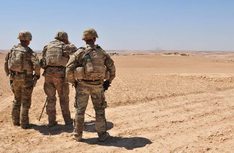  A group of U.S. Soldiers observe Turkish military forces on the other side of the demarcation line outside Manbij, Syria, August 11, 2018. (credit: PICRYL)
