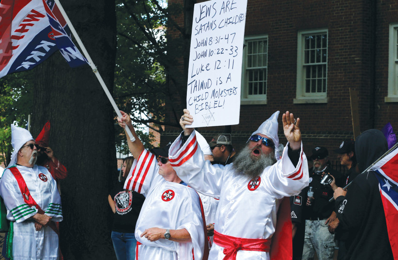  MEMBERS OF the Ku Klux Klan rally in Charlottesville, Virginia, in 2017. Antisemitism is a growing and worrisome problem in the United States, the writer asserts. (credit: JONATHAN ERNST/REUTERS)